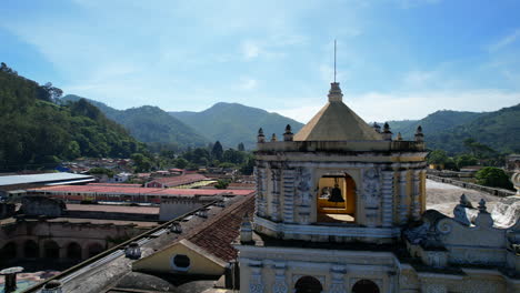Aerial-view:-Iglesia-de-la-Merced,-Antigua-Guatemala,-under-blue-skies
