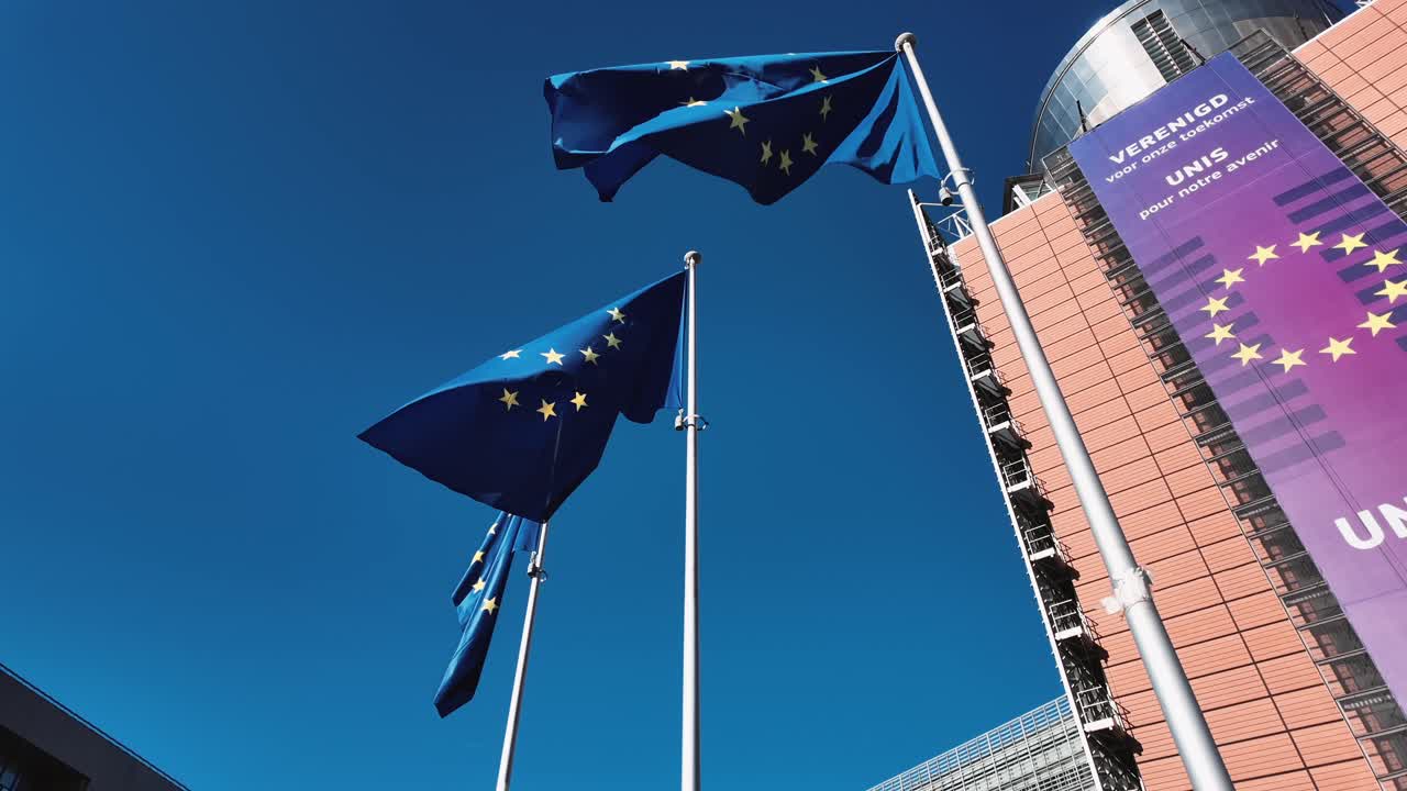 European Union flags waving outside the Berlaymont building in Brussels