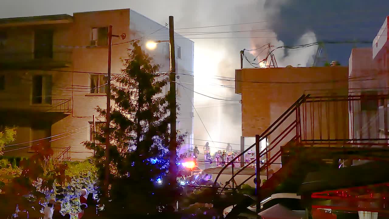 Firefighters at the scene of fire extinguish building on fire Montreal Canada