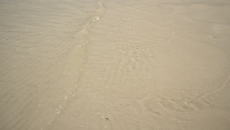 ocean waves calmly glide through the sand 4k uhd