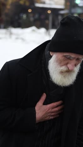 chest pain in an elderly man with a white beard, vertical video.
