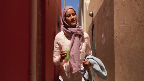 young woman wearing hijab out and about in the city