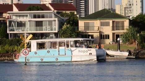 a ferry boat travels past waterfront homes