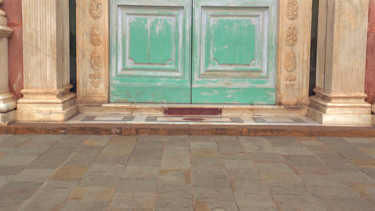 Closeup of ornate green door with marble columns and carvings italian renaissance design
