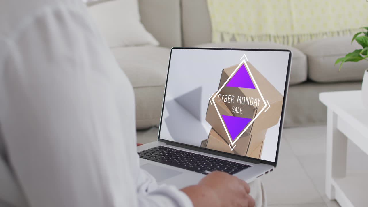 Biracial woman using laptop at home for online shopping, slow motion
