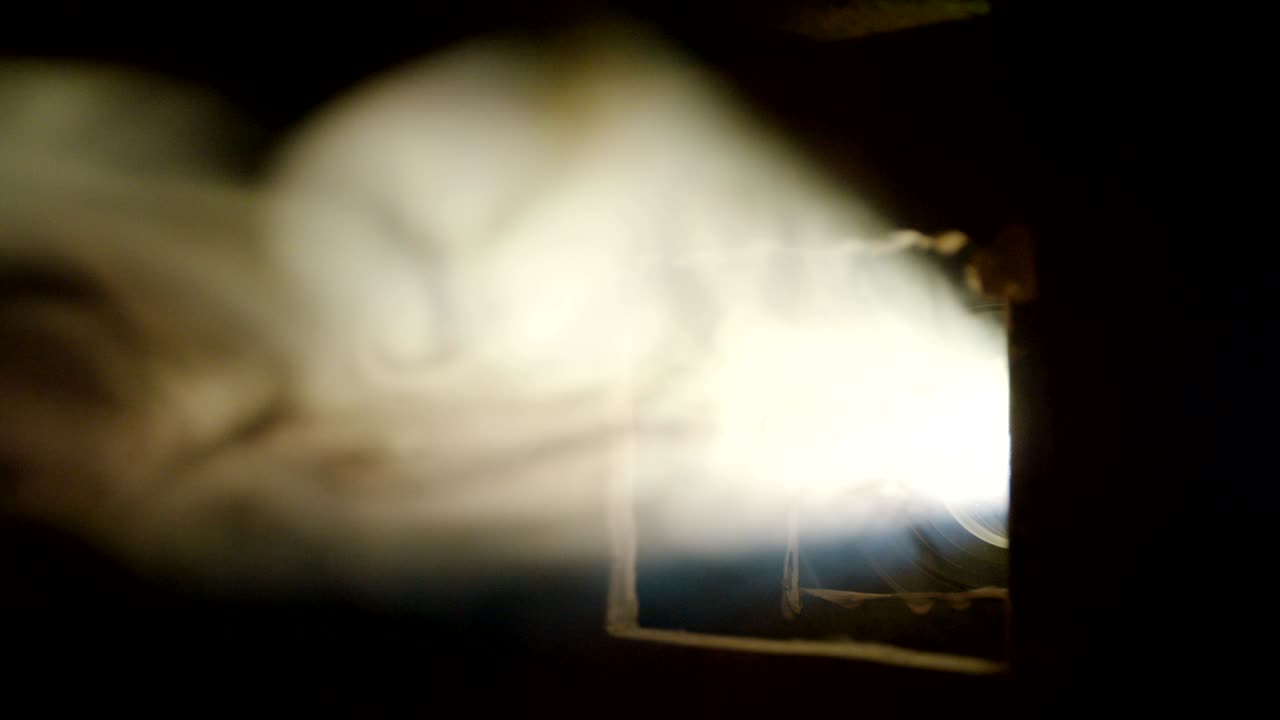 luces de proyector de cine en una habitación oscura con humo
