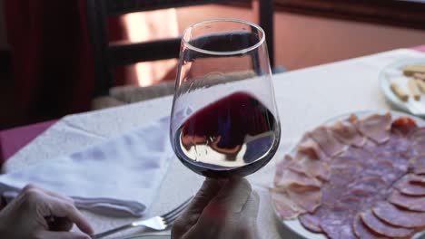 anonymous person with glass of red wine