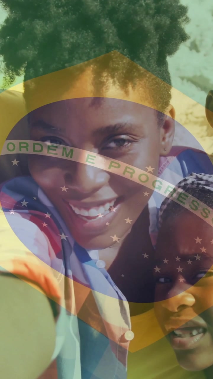 Brazilian flag animation over smiling family taking selfie on beach