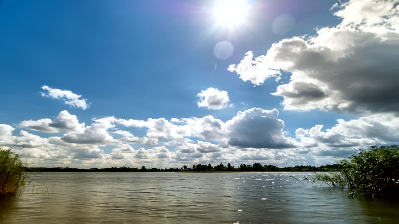 White Clouds on Blue Sky Over Lake Time Lapse