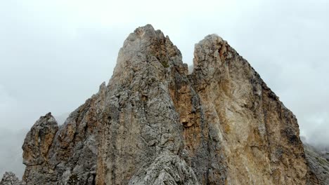 aerial views of italian dolomites peaks in a foggy and cloudy day