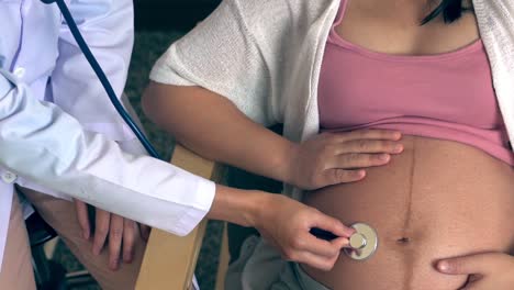 pregnant woman and gynecologist doctor at hospital