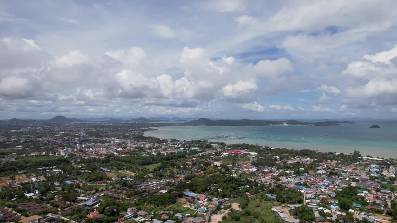 Phuket, aerial drone shot over a Rawai Mueang district on a beautiful sunny day, a turquoise lagoon facing Phi Phi island in a famous Thailand tourist location