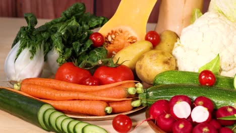 assorted vegetables displayed on a wooden surface