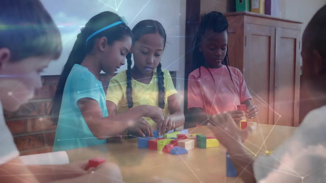 Elementary students reaching into blocks in classroom, sharing and stacking shapes for learning