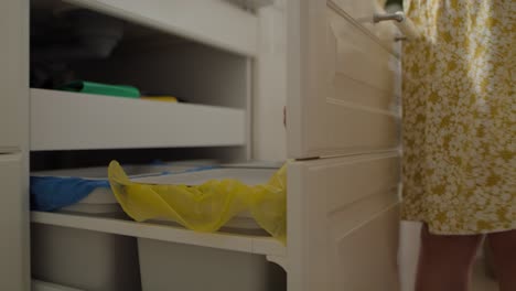 tracking video of girl throws plastic bottle into the trash