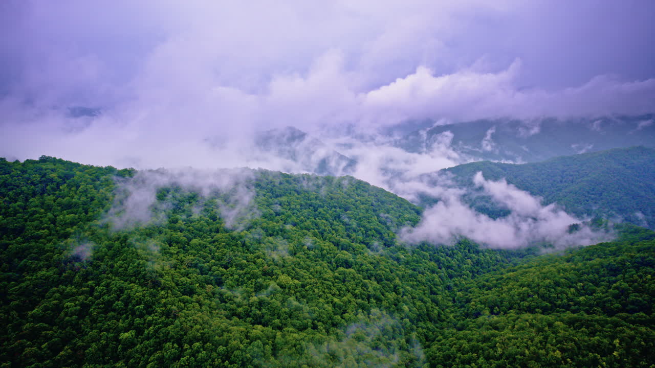 Wide cinematic aerial of fog-drenched Smoky Mountain terrain