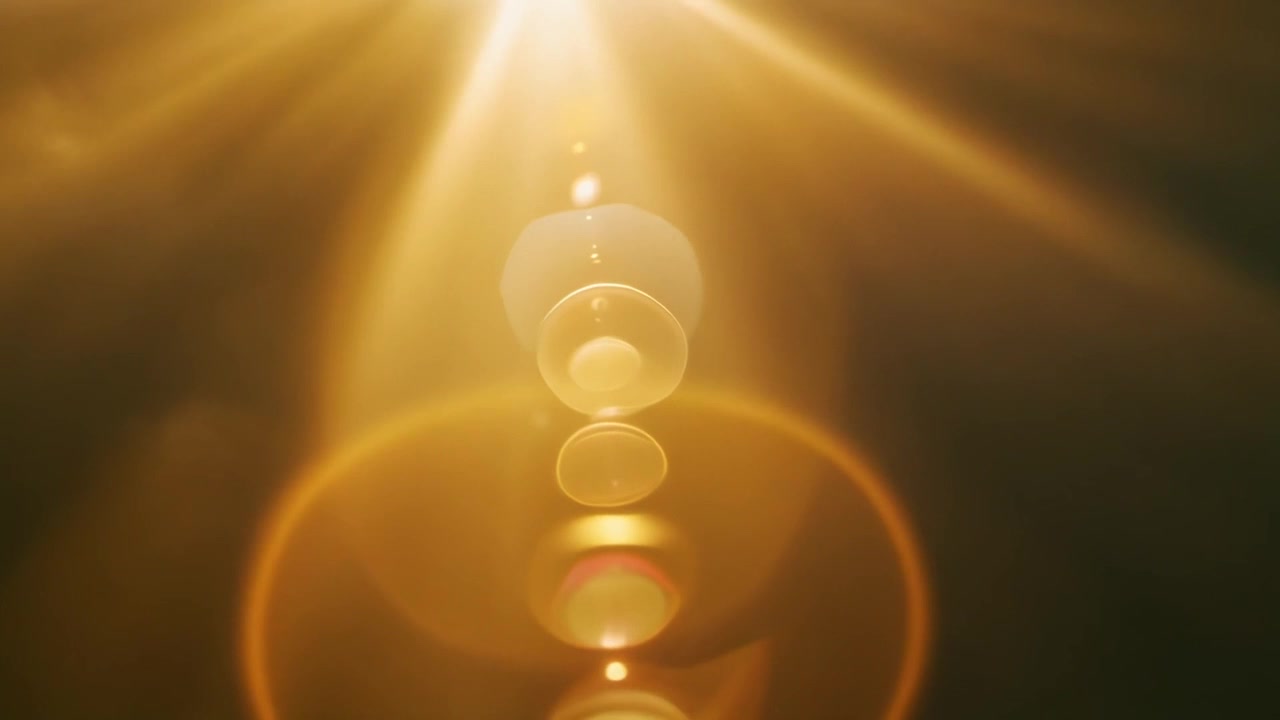 Golden Lens Flare Effect with Glowing Light Rays