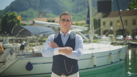 stylish man posing at yacht dock