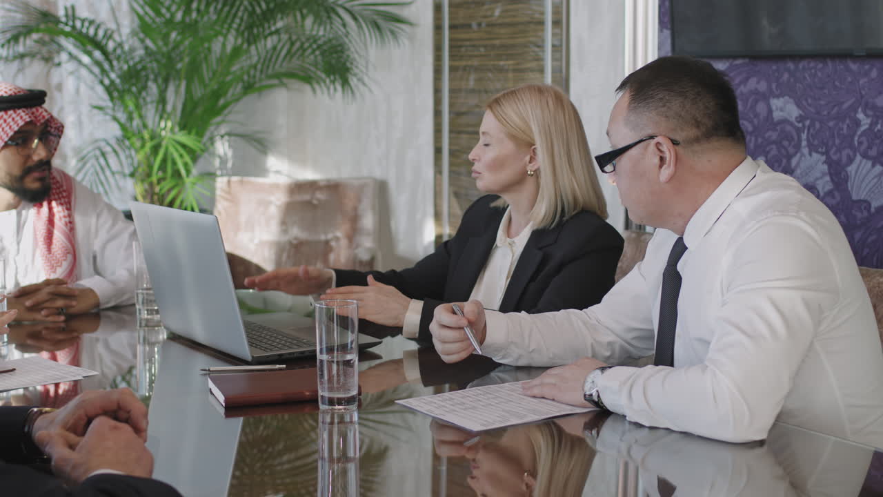 Multi-Ethnic Team Of Investors Discussing Business Strategy