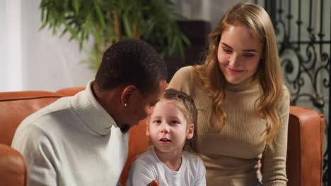 daughter talks to father looking at family photo album