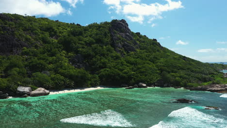 Drone-flying-over-a-beautiful-beach-on-La-Digue-Island-in-the-Seychelles,-Africa