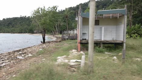 moving-right-trucking-shot-of-a-abandoned-derelict-destroyed-beach-bungalow-resort-with-ocean-palms-and-broken-down-bungalows-from-the-effects-of-covid-19-on-tourism