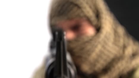 Soldier-with-covered-face-aiming-rifle