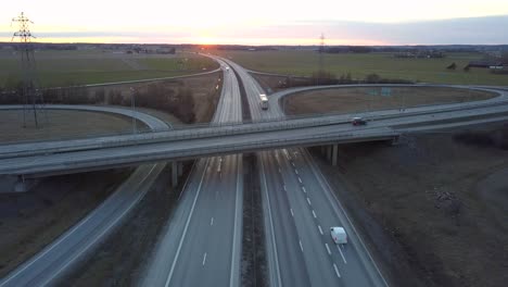 aerial view of freeway intersection with moving traffic cars.