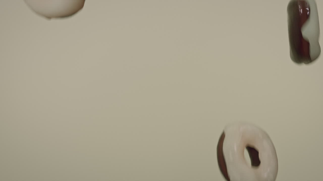 White glaze donuts on a light green background