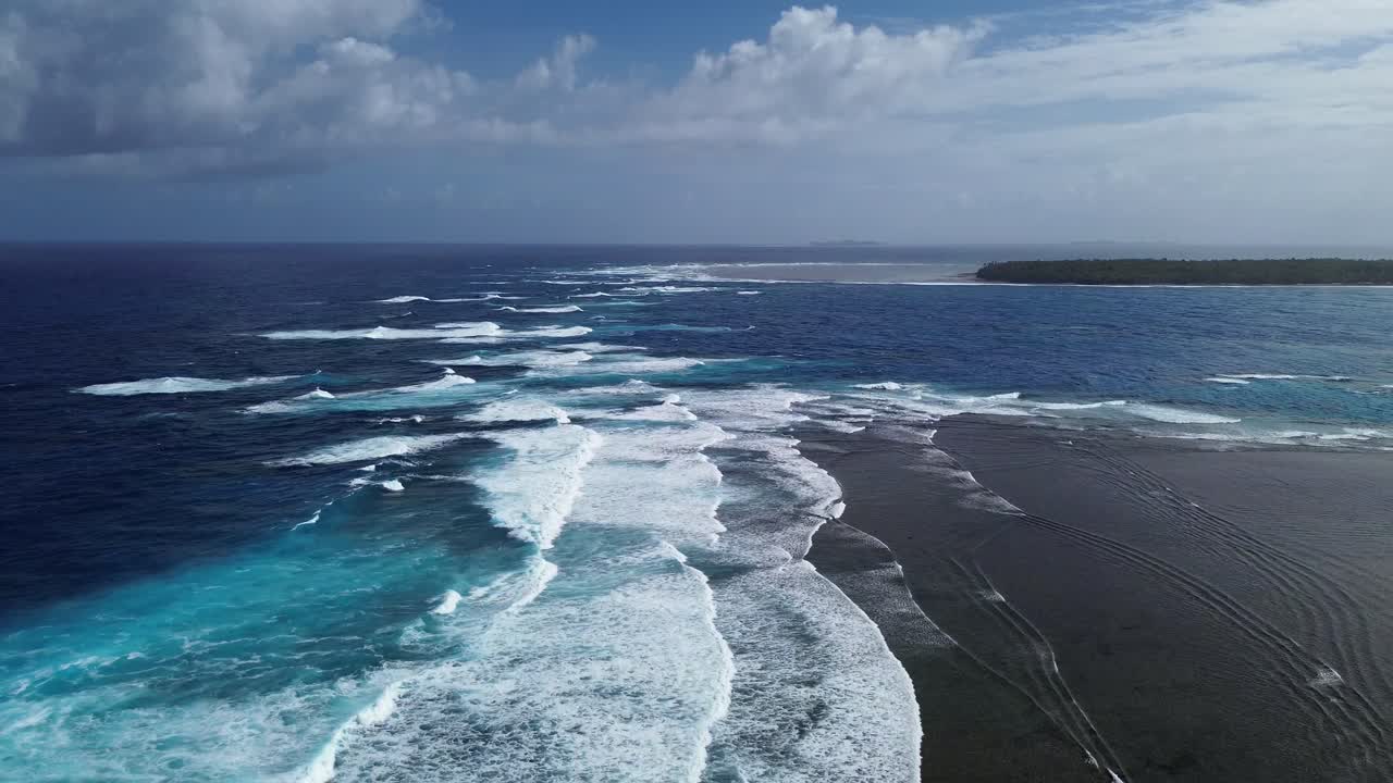 Backward glide drone shot of ocean waves in tropical Siargao Island, Philippines