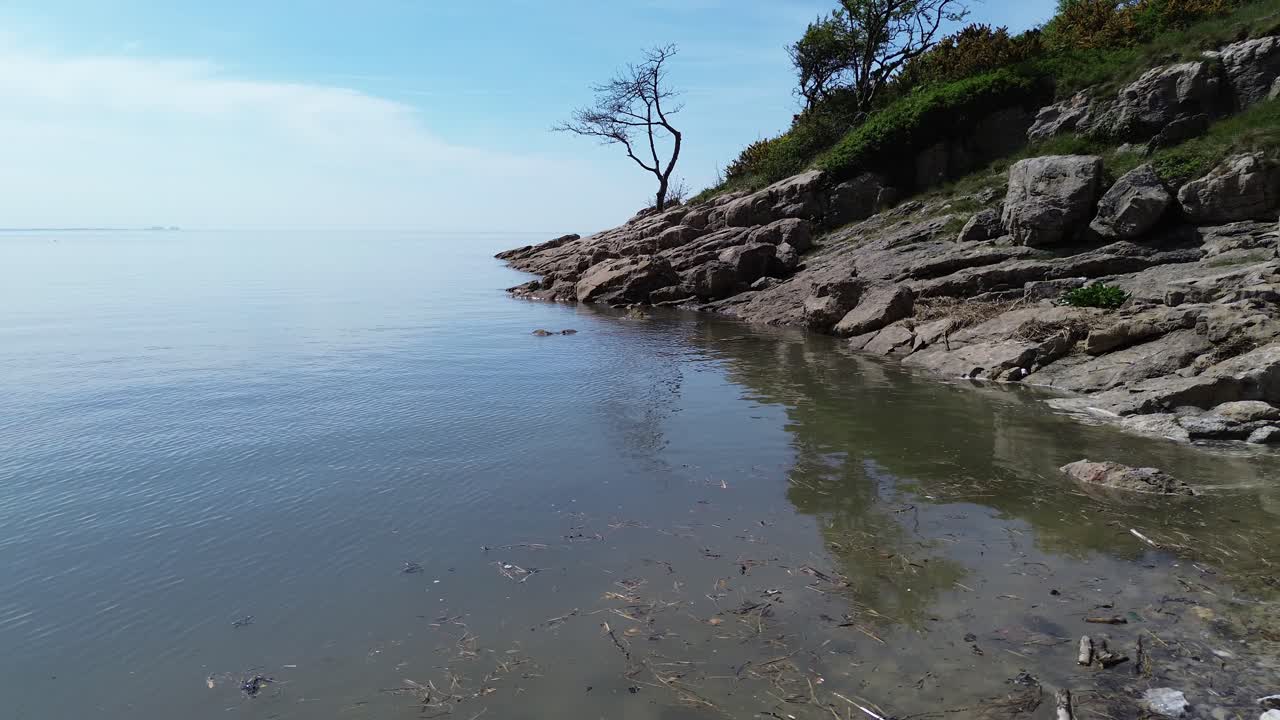 Aerial view from idyllic dreamlike rocky coastal slope to private paradise white stone beach