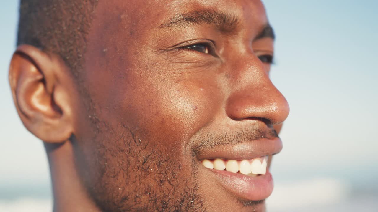 Portrait of African American man smiling at beach