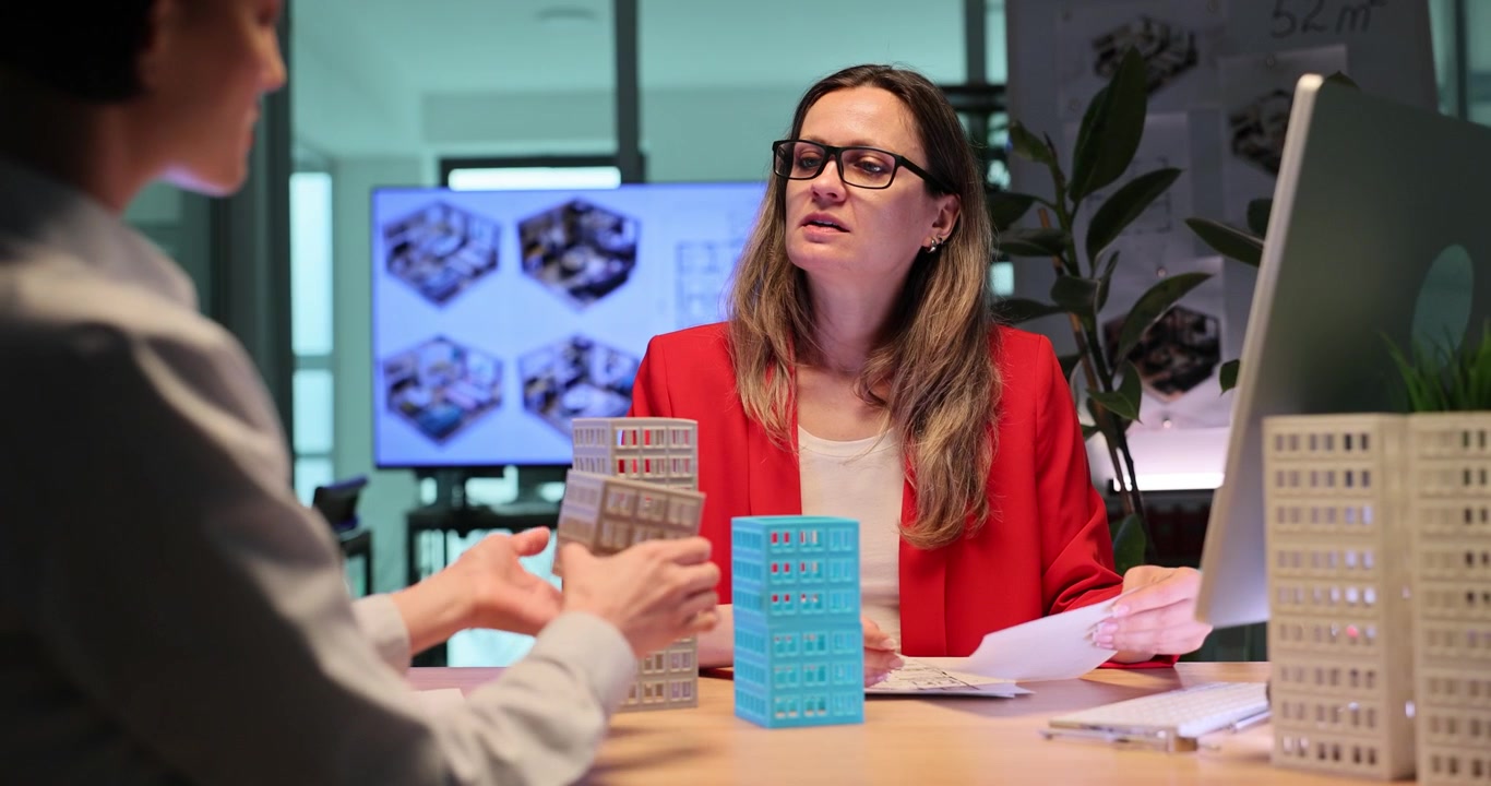 Architects study detailed toy models of multistory buildings