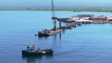 Aerial-view-of-cruising-ship-leaving-constriction-site-of-cabo-rojo-cruise-terminal-with-hotel-apartments