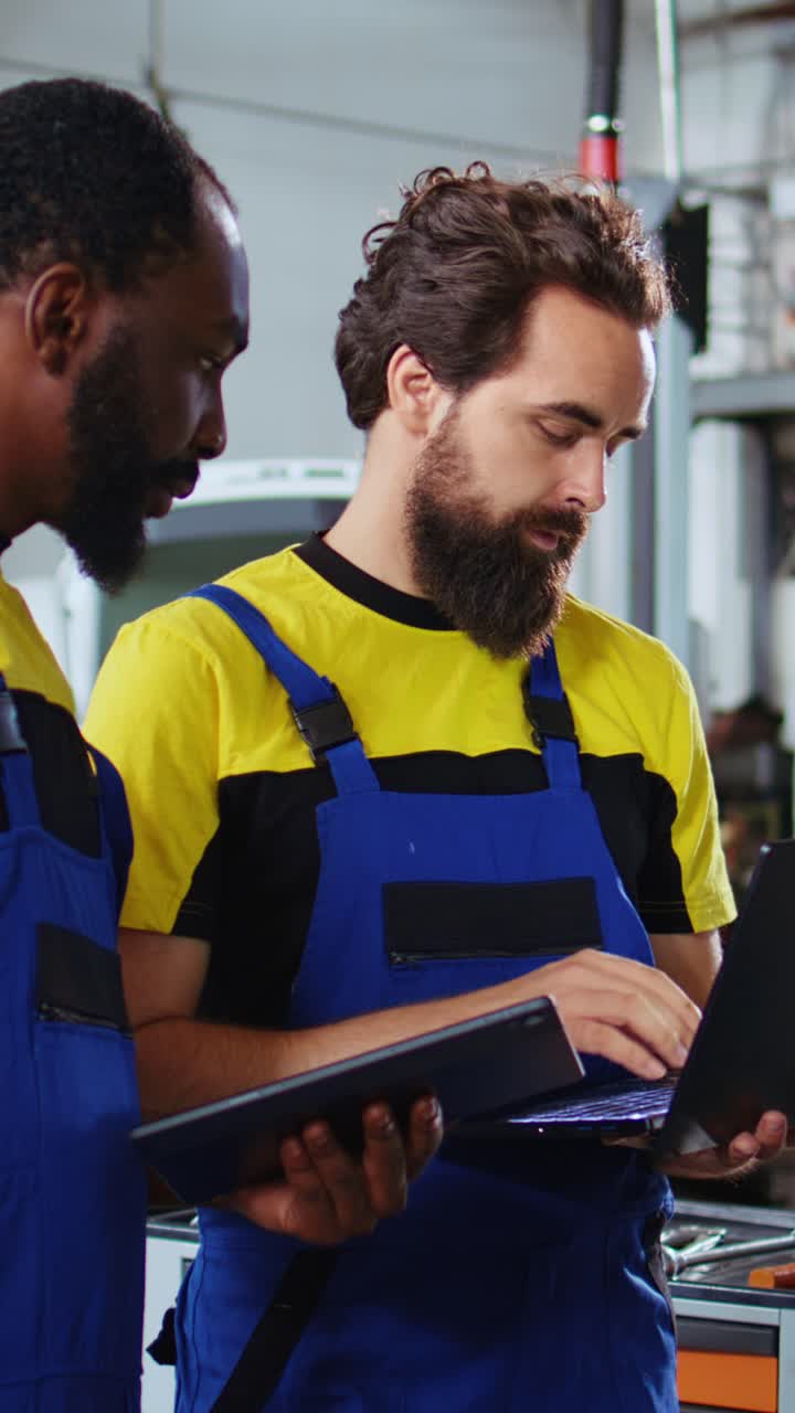 Vertical video Employees working together to fix car