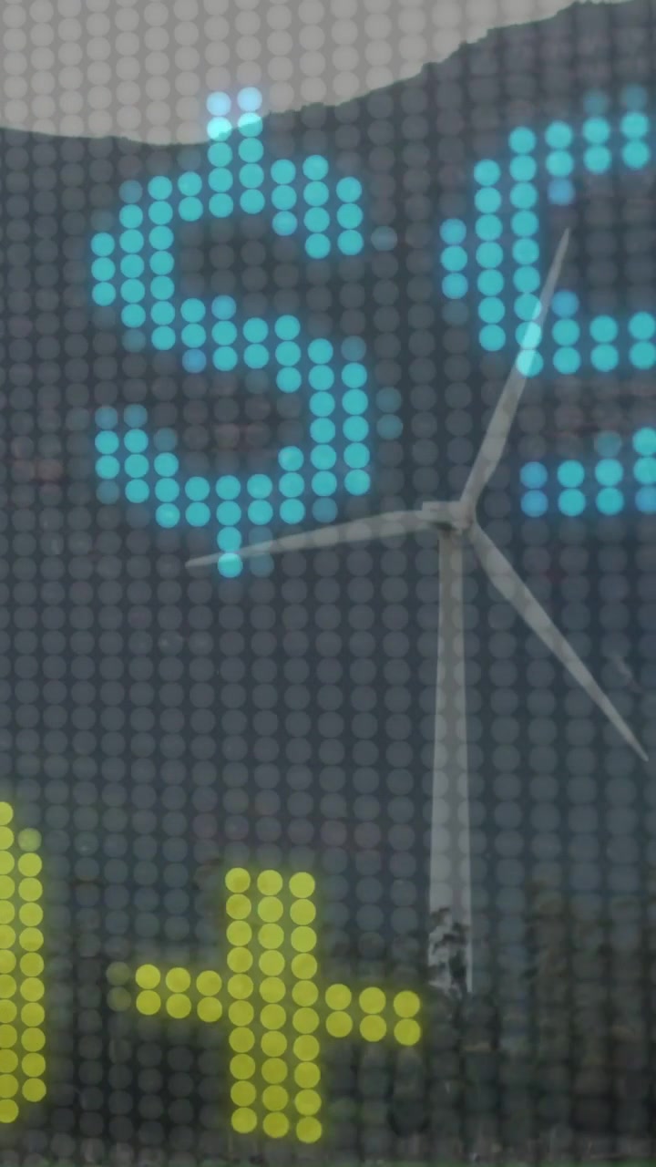 Video verticale: Display che si aggiorna con i dati della turbina per l'energia, con pixel che attraversano le pale del rotore.