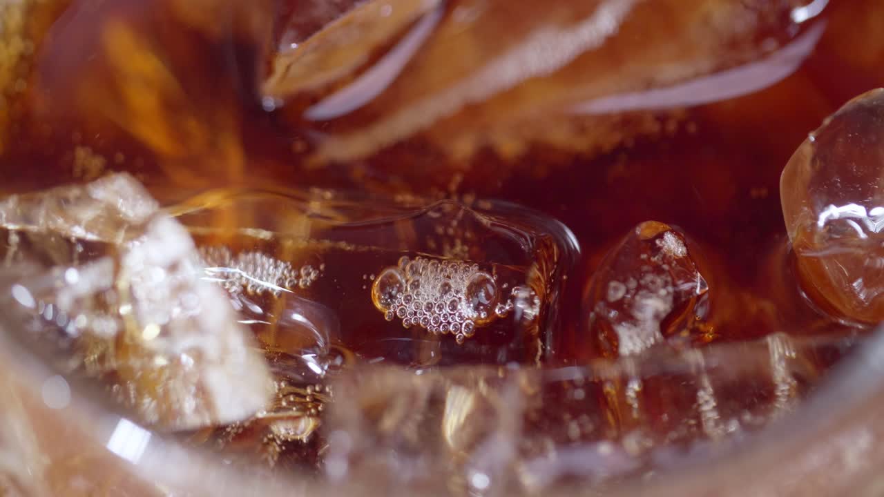 A close-up shot of ice-cold beverage with bubbles capturing the essence of refreshment