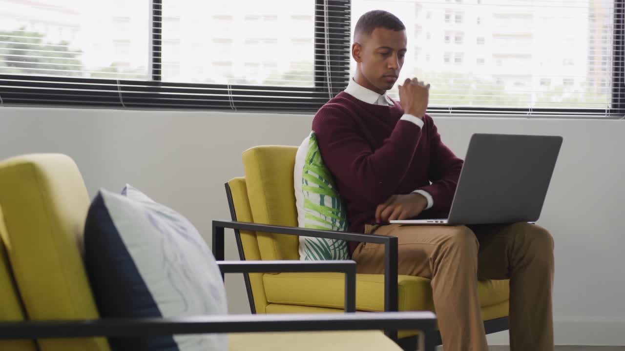 Mixed race man working on laptop