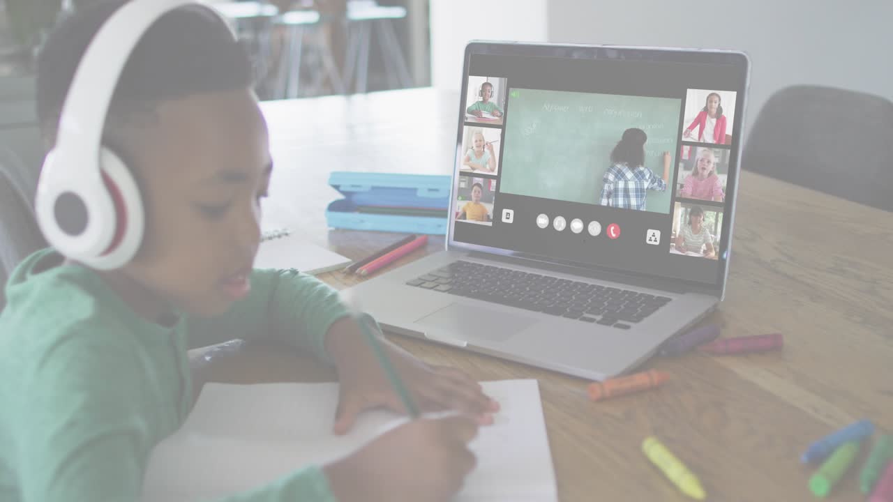 Boy student writing at desk while online class activating ID HUD expanding over laptop for login