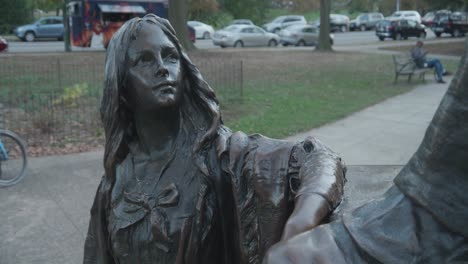 close-up of a bronze statue of a girl in a park