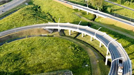 highway bridge with driving cars lit by sun in morning