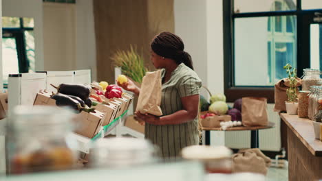 woman looking at freshly harvested colorful veggies in crates