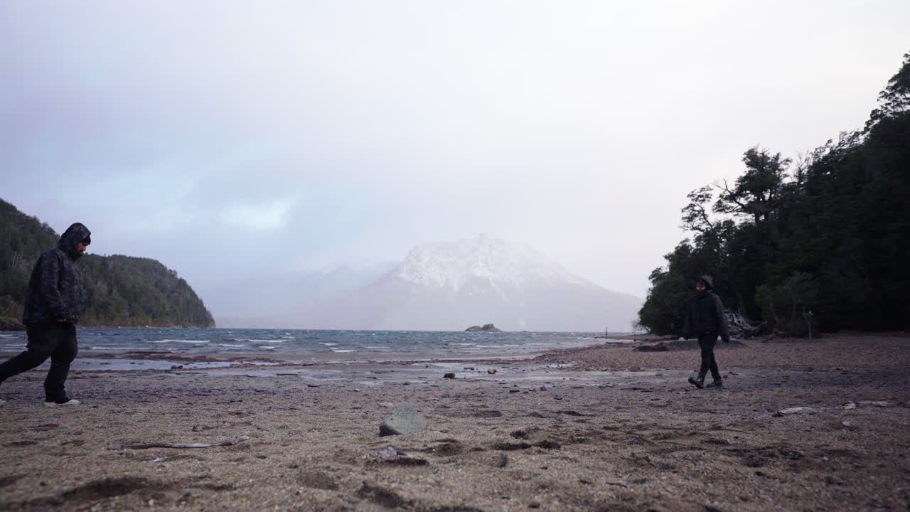 Young couple meet and argue on lonely exotic beach in winter