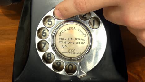 a close of up an old vintage rotary dial telephone