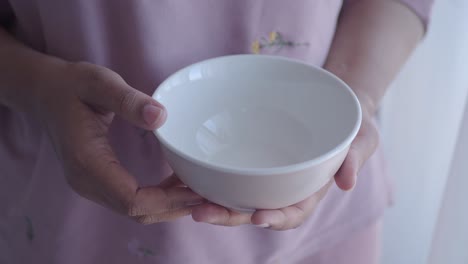 woman holding an empty bowl