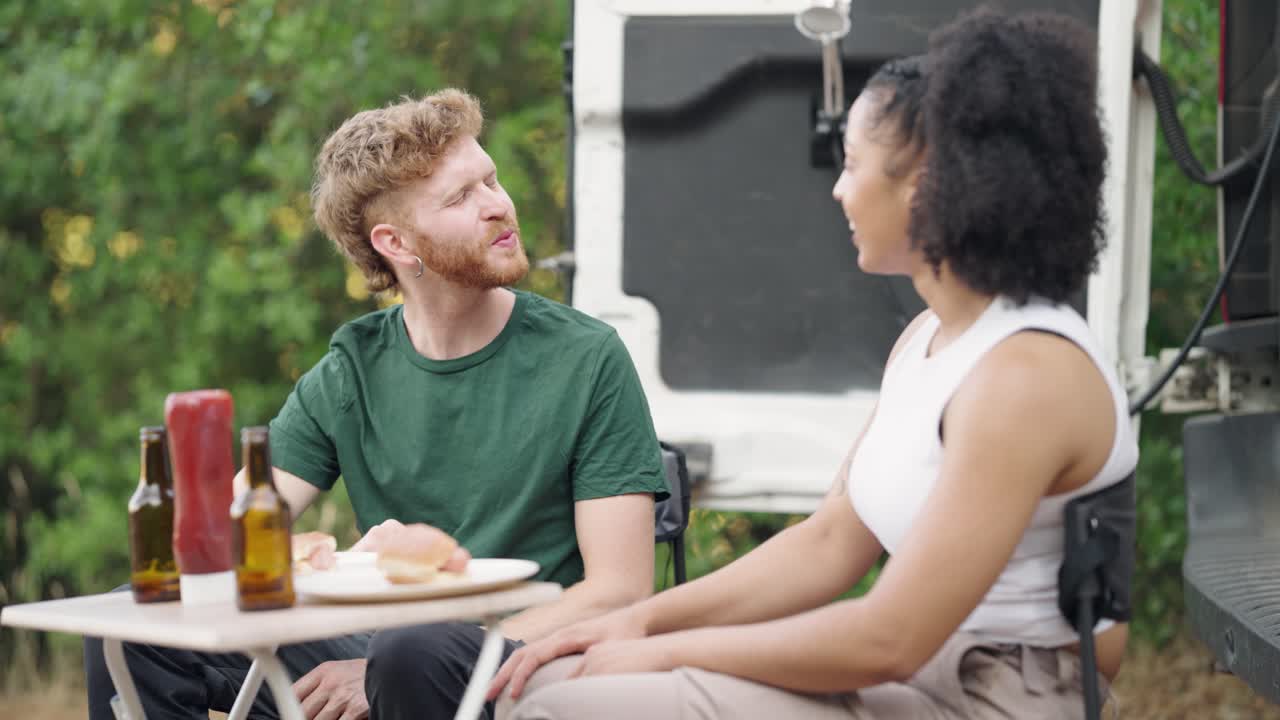 People enjoying a picnic by the van