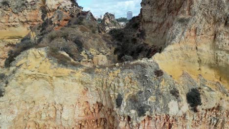 algarve rocky limestone cliff coastline eroded atlantic ocean in portugal, aerial