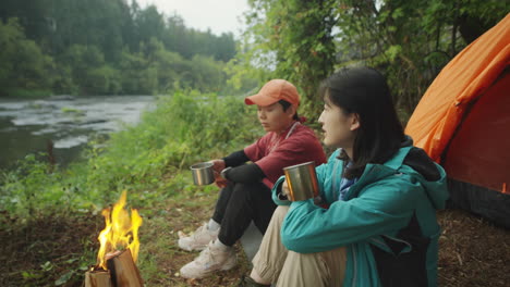 asian female tourists speaking at campsite