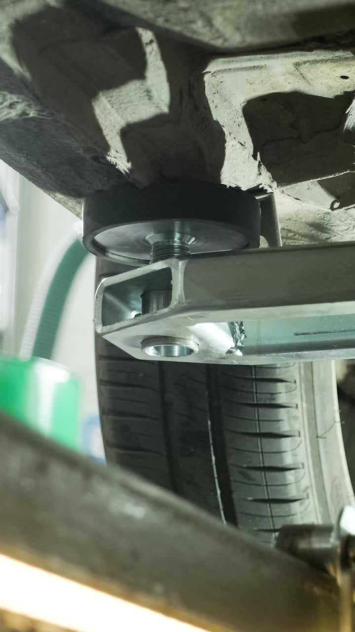Lähikuva auton alustasta nosturilla autokorjaamolla