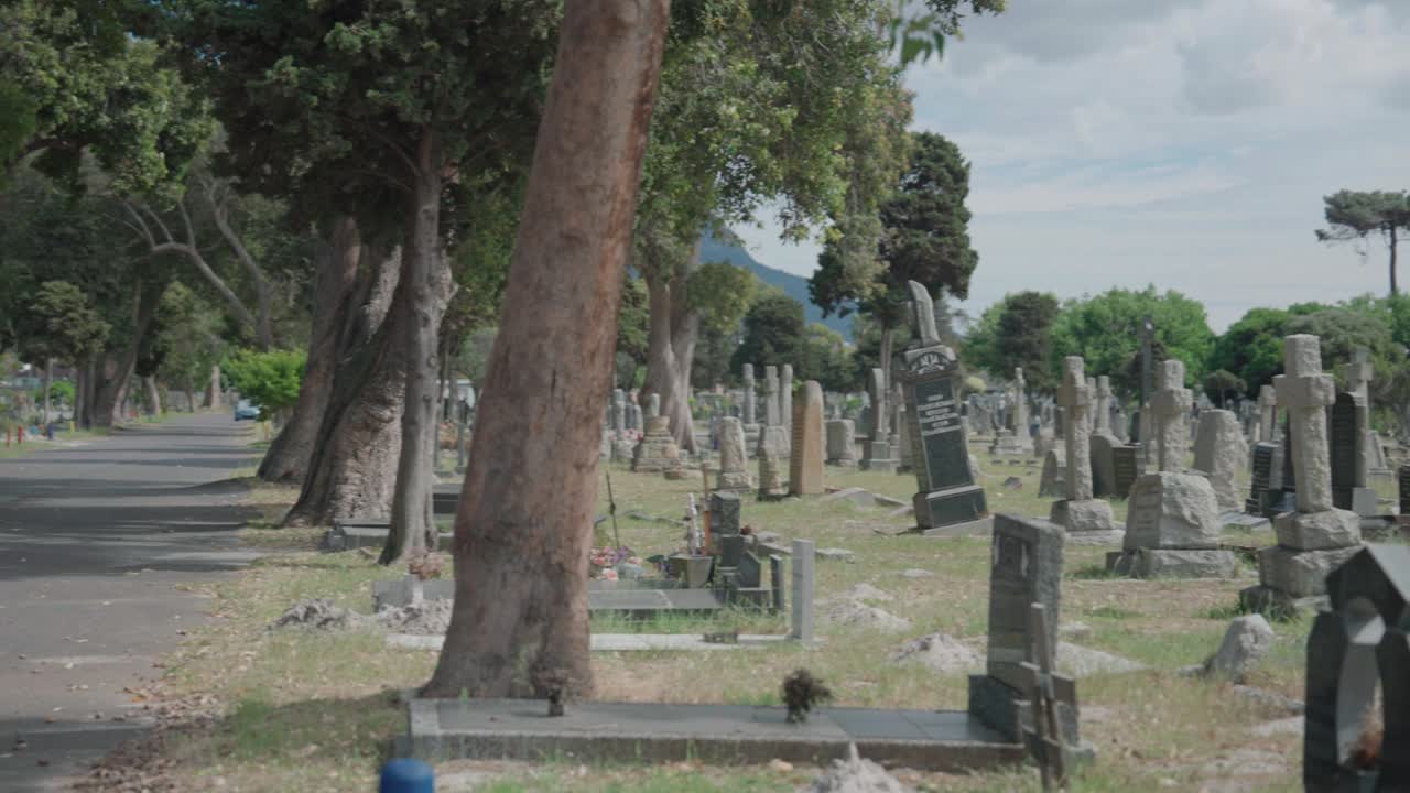 Distant view of gloomy day with crosses in graveyard